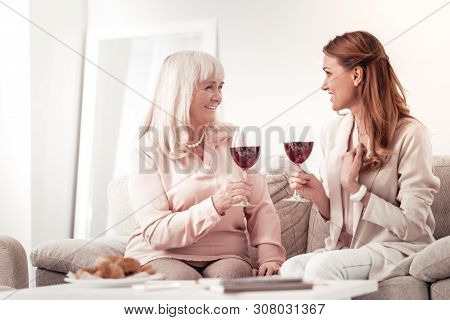 Positive Long-haired Woman Saying Good News To Her Mother