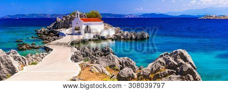 Authentic traditional Greek islands- unspoiled Chios, little church in the sea over the rocks Agios Isidoros