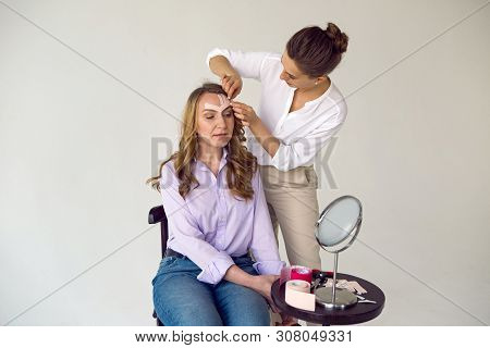 Beautician Aesthetician Glues Kinesio Tape On The Face