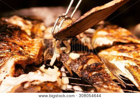Cooking Fish On The Grill. Fried Fish. Fried Fish On The Fire. Close-up. Moment Of Cooking