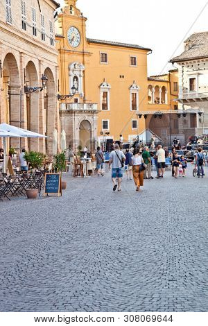 Fermo, Italy - June 23, 2019: People enjoying summer day and food at outdoor restaurant and resting, Piazza del Popolo, Fermo, Italy