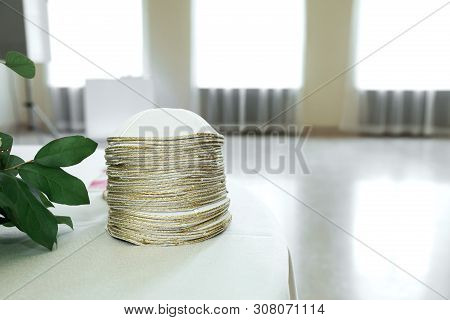 Many White Gold-plated Jewish Kippa Headdresses Stacked On The Table.