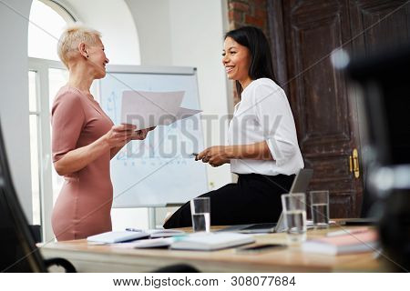 Side View Portrait Of Two Successful Businesswomen Chatting Cheerfully While Working In Office, Copy