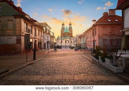 Historical Road Leading Towards Gniezno Royal Cathedral On A Sunset. Gniezno Town, Former Capital Of