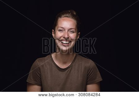 Close Up Portrait Of Young Woman Isolated On Black Studio Background. Photoshot Of Real Emotions Of 