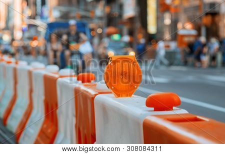 Roadblock Or Construction With Signal On A Road Red And White Street Barricade.
