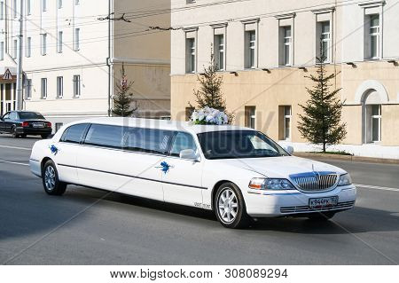 Ufa, Russia - September 12, 2009: White Wedding Stretch Car Lincoln Town Car In The City Street.