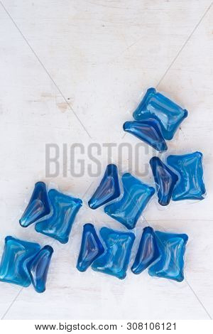 Set Of Blue Washing Detergent Capsule Isolated On White Wooden Background. Close-up.liquid Soap.