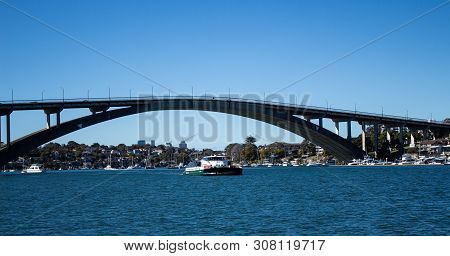 Gladesville Bridge Spanning Parramatta River Off Sydney Harbour With Rivercat Ferry Travelling Upstr