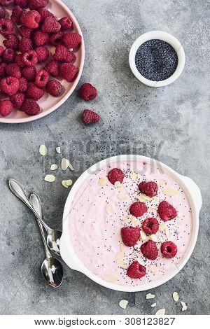 Raspberry Dessert, Yogurt And Fresh Raspberries On A Gray Stone Background.