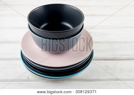 Set Of Clean Pastel Ceramic Crockery Tableware On Wooden Background.  Color Bowls, Dishes. Top View.