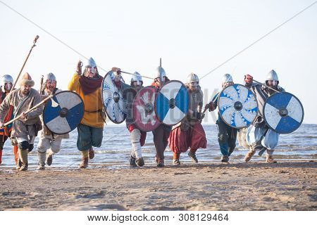 Slavic Warriors Reenactors With Wearpons And Shields Training Fighting Outdoors At Seaside