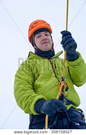 Ice Climber Belay With A Rope And Click Up. Hands Close Up