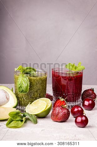 Green And Red Smoothie Of Strawberry, Sweet Cherry, Avocado, Spinach, Basil, Lime, Green Apple On Gr