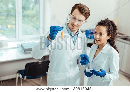 Professional Young Scientists Looking At The Test Tube