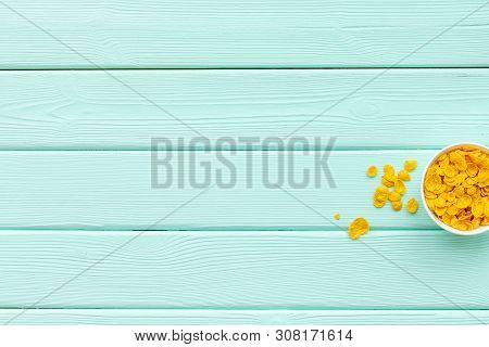 Cereals, Oatflakes And Cornflakes For Healthy Breakfast On Mint Wooden Background Top View Mock Up