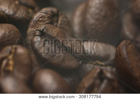 Macro Coffee Beans With Smoke Can Use As Background.