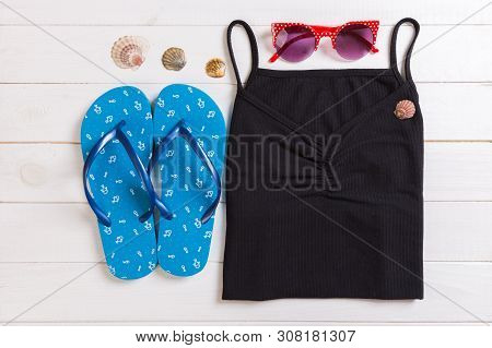 Summer Accessories With T-shirt, Seashells And Flip Fops On White Wooden Background Top View Flat La