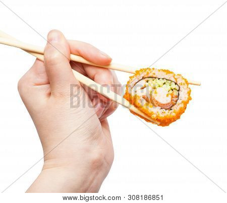 Female Hand With Disposable Chopsticks Holds California Ebi Sushi Roll Isolated On White Background