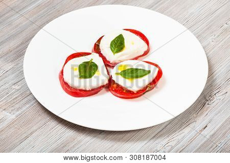 Italian Cuisine Insalata Caprese (caprese Salad) - Stacks From Sliced Mozzarella Cheese, Tomato, Bas