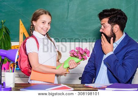 Knowledge Day Is 1 September. Teachers Day. Daugghter And Father With Flowers. Small School Girl Kid
