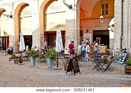 Fermo, Italy - June 23, 2019: People enjoying summer day and food at outdoor restaurant and resting, Piazza del Popolo, Fermo, Italy