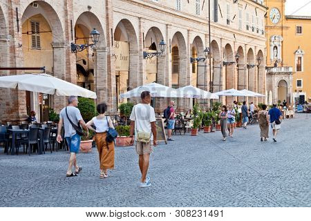Fermo, Italy - June 23, 2019: People enjoying summer day and food at outdoor restaurant and resting, Piazza del Popolo, Fermo, Italy