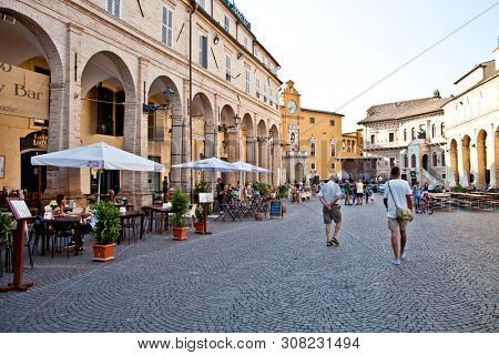Fermo, Italy - June 23, 2019: People enjoying summer day and food at outdoor restaurant and resting, Piazza del Popolo, Fermo, Italy