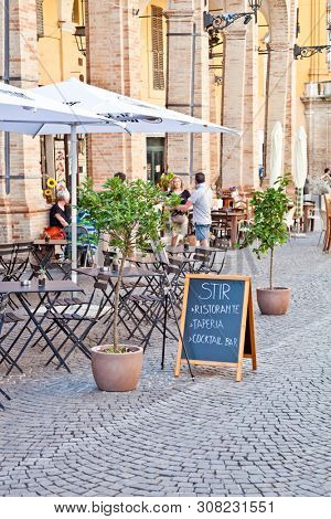 Fermo, Italy - June 23, 2019: People enjoying summer day and food at outdoor restaurant and resting, Piazza del Popolo, Fermo, Italy