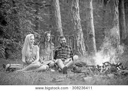 Camping Travel And Wanderlust. Bearded Man And Women Smile At Bonfire. Happy Friends At Campfire. Hi