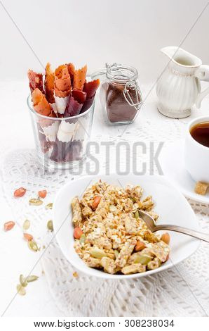 Granola From Several Types Of Cereals With Nuts,coconut Chips And Dried Fruits  In White Plate For B