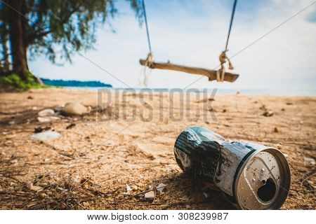 Cans On The Beach Destroy The Environment. Garbage In The Sand On Nature. Trash On On A Beautiful Be