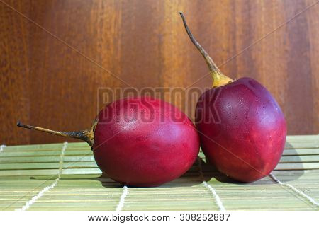 Tamarillo Exotic Fruit Of South America. Fresh And Delicious Fruit Tamarillo On A Wooden Background