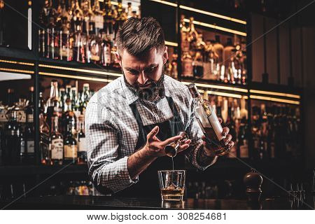 Diligent Happy Barman Is Preparing Alcoholic Beverege For Customer.