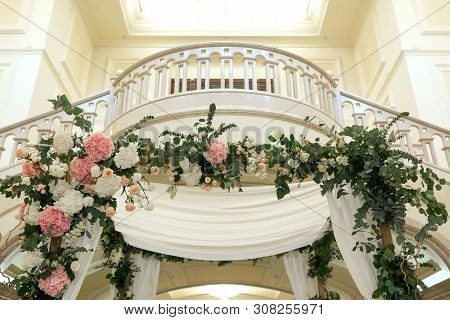 Wedding Chuppah Decorated With Fresh Flowers Indoor Banquet Hall Of Wedding Ceremony. Luxury Wedding