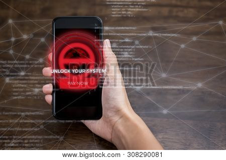 Hand Holding Smartphone That The System Being Locked By Ransomware Cyber Attack