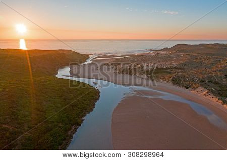 Aerial from Amoreira beach on the westcoast in Portugal at sunset