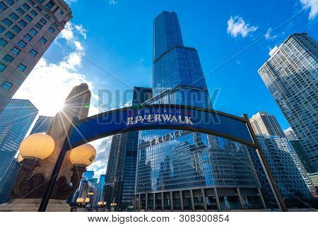 Chicago, Illinois, Usa - Mar 15th,2019 : Chicago Riverwalk Sign With Trump Building With Sky Blue In