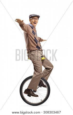Full length shot of a senior man riding a mono-cycle and balancing with hands isolated on white background