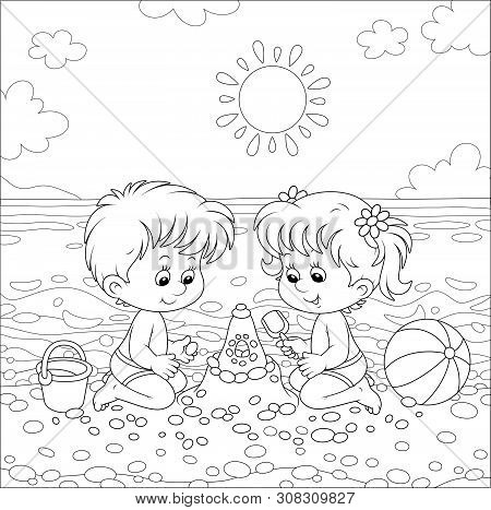 Happy Little Kids Playing And Making A Fancy Sand Castle Near Water On A Sea Beach On A Sunny Summer
