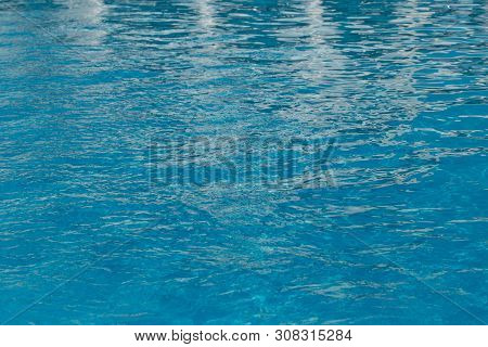 Blurred Water Texture In Summer Pool Close Up.