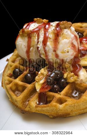 Gofre - Belgian Homemade Waffles With Ice Cream, Bananas And Nuts On A White Plate