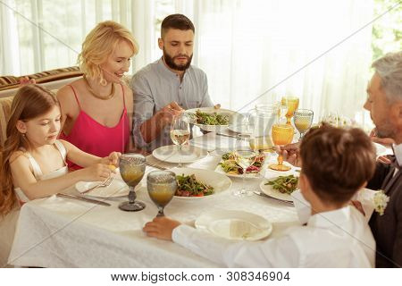 Big Family Having Lunch While Celebrating Wedding Of Parents