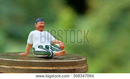 Close Up Conceptual, Midle Aged Man Enjoy His Earn Or Income, Sit At Stack Of 500 Golden Coins, With