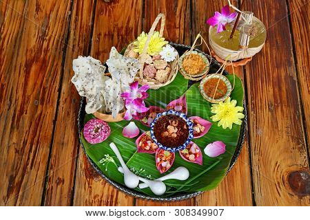 Thai Appetizer Set Of Fresh Lotus Petal Wrapped And Crispy Fried Rice Cakes With Calamansi Citrus Ju