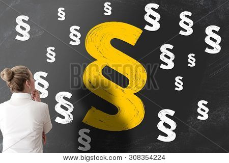 Woman Looking At Blackboard Filled With Section Signs Or Paragraph Marks, Legal Problems Concept