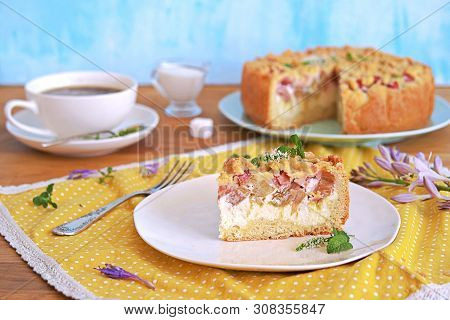 Dessert, Sliced Shortcrust Cake With Rhubarb And Cottage Cheese Or Ricotta On A White Plate.