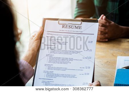Interviewer Reading A Resume, Person Submits Job Application, Person Describe Yourself To Interviewe