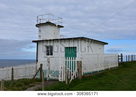 Coastguard Station Located On The Sea Cliffs Above Fleswick Bay In England.