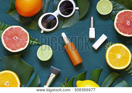 Cosmetic Flat Lay With Vitamin C Serum And Citrus On The Back Wooden Background. Top View